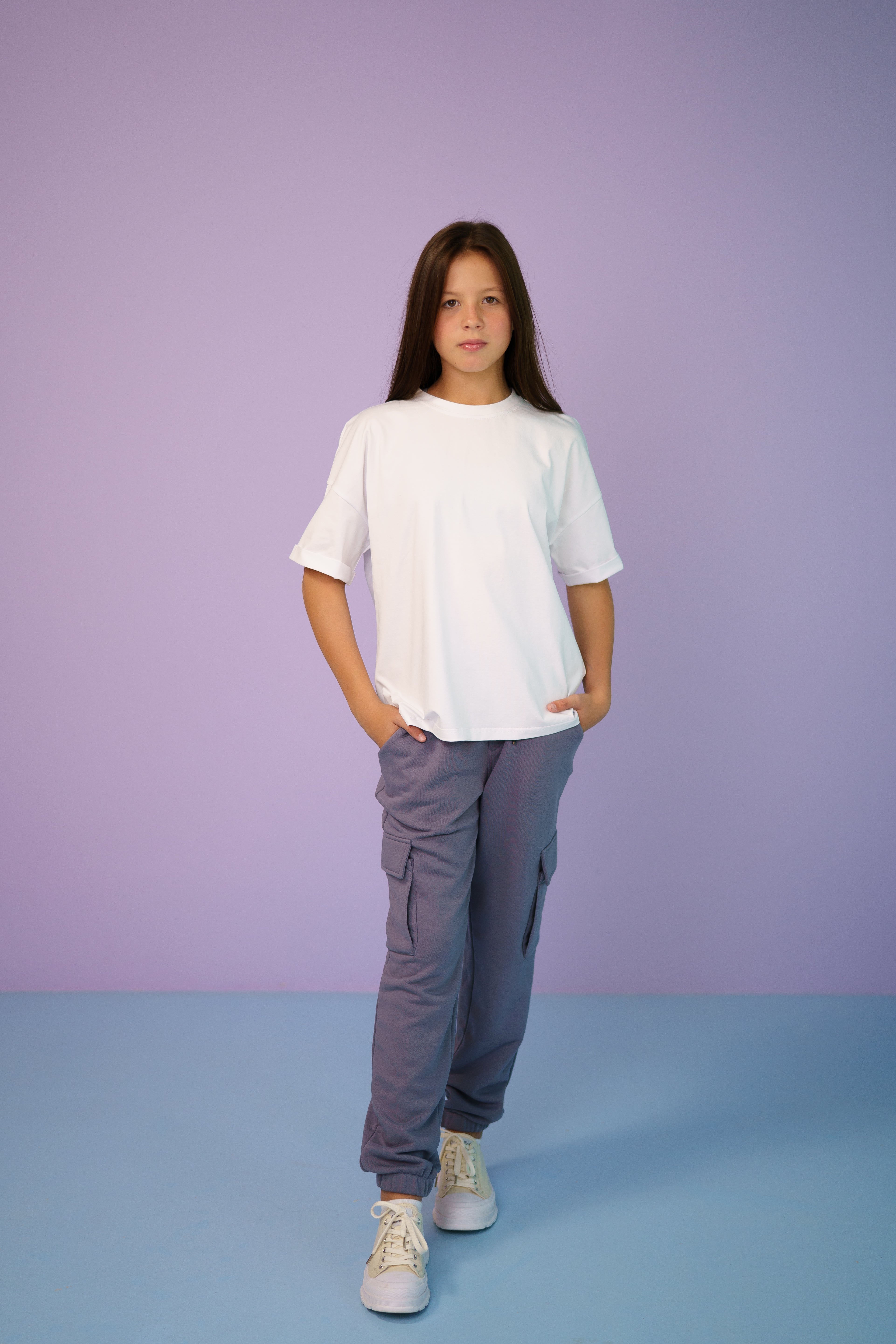 girl wearing gray joggers and a white oversize t-shirt
